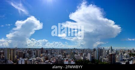 impressive Cumulonimbus clouds rising in the blue sky over Buenos Aires, Belgrano neighborhood. High resolution panorama Stock Photo