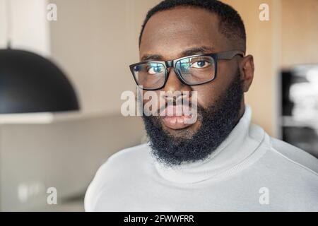 Serious young african american man in eyeglasses looking at camera closeup Stock Photo