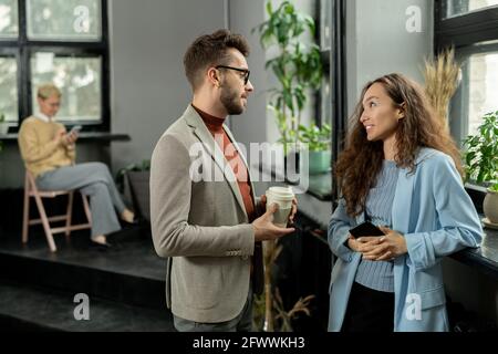 Two young managers talking at break in office environment Stock Photo