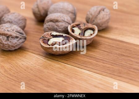 Ripe walnuts on wooden rustic backdrop. Healthy nut food for brain. Fresh walnuts background concept Stock Photo