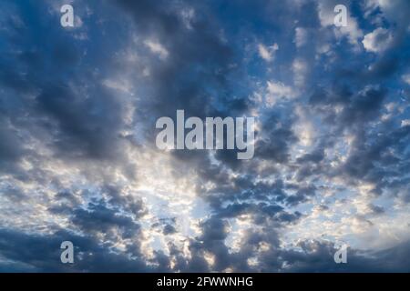 Beautiful clouds of different shapes in the sky before sunset Stock Photo