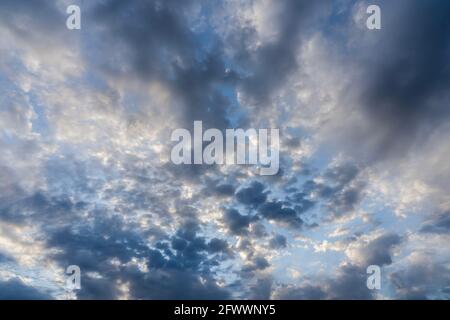 Beautiful clouds of different shapes in the sky before sunset Stock Photo