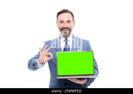 office manager ready for video conference. happy grizzled man showing laptop screen. Stock Photo