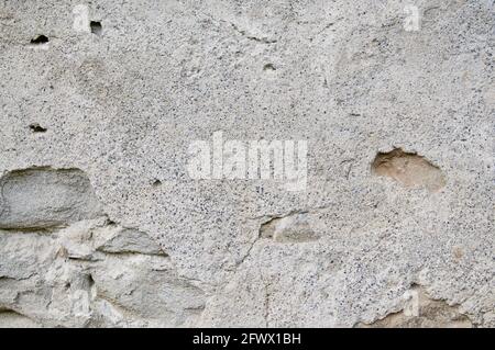 Aged grey street wall background with some cracks Stock Photo