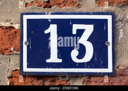 Number 13 in white on a blue metal plate Stock Photo