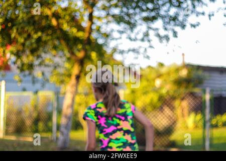 Defocus abstract bright yellow colorful sport background. Person back. Skate penny board. Girl running. Stylish youth culture backdrop. No focus. Out Stock Photo