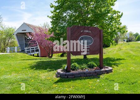 St. Charles, Iowa - May 4, 2021: Sign and the Imes Covered bridge, gateway to the covered bridges of Madison County Stock Photo