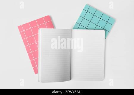 Checkered notebooks on white background Stock Photo