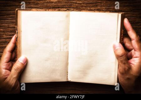 The man opening a vintage book with blank pages. Stock Photo