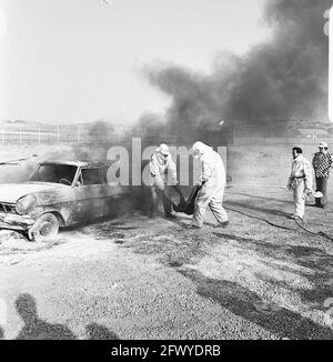 Rescue demonstration at circuit of Zandvoort, volunteers pull drivers from wreck, 9 April 1974, VOLUNTEERS, demonstrations, The Netherlands, 20th century press agency photo, news to remember, documentary, historic photography 1945-1990, visual stories, human history of the Twentieth Century, capturing moments in time Stock Photo