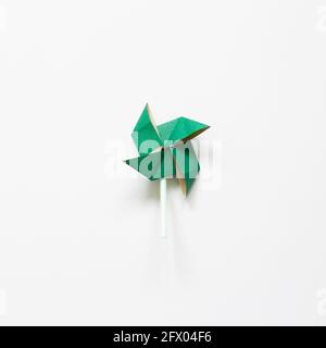 Green paper pinwheel isolated on white background. top view Stock Photo