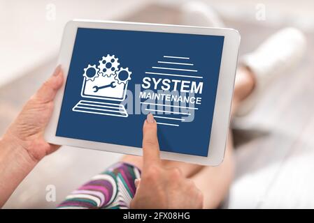 Woman using a tablet with system maintenance concept Stock Photo