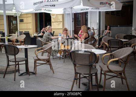 Belgrade, Serbia, May 23, 2021: View of a street café with seated guests under umbrellas Stock Photo