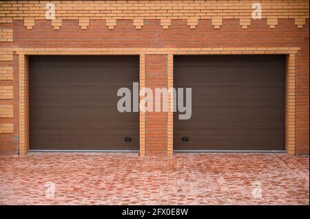 Double garage doors jalousie on red brick wall Stock Photo