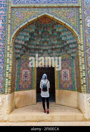 Woman tourist in a colourful arabian mosque. Stock Photo