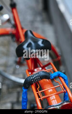 BAMBERG, GERMANY - Dec 06, 2020: Combination lock anti theft red city bike Stock Photo