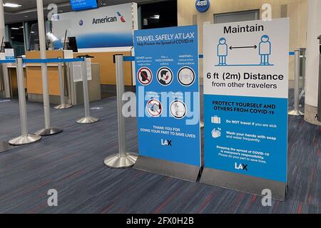 COVID-19 safety travel advisories signs at Gate 48B of Terminal 4 of the Los Angeles International Airport, Tuesday, May 24, 2021, in Los Angeles. Kir Stock Photo