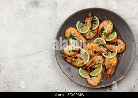 Steamed prawns in a plate on a light background. Top view, flat lay Stock Photo