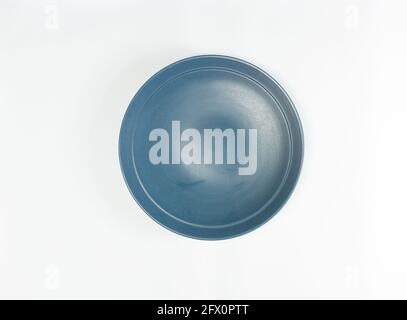 Indonesian-made ceramic plates are Tosca green on a white background Stock Photo