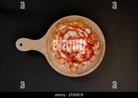 Closeup top view of pizza on a wooden tray. Stock Photo