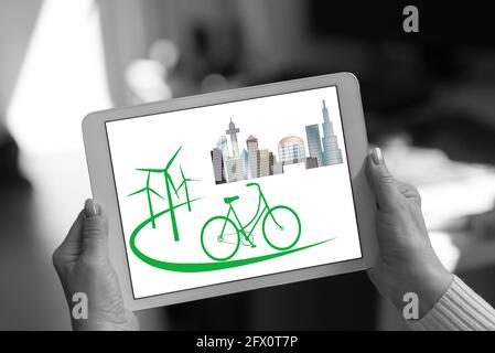 Eco friendly concept shown on a tablet held by a woman Stock Photo