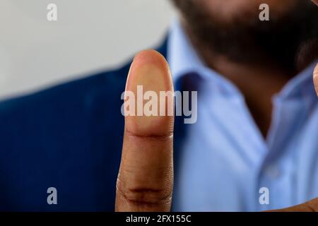 Close up of businessman touching invisible screen against grey background Stock Photo