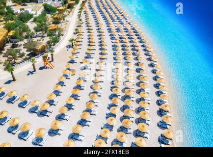 Aerial view of sea, empty sandy beach with sunbeds and umbrellas Stock Photo