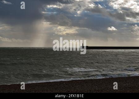Newhaven Harbour Arm seen from Seaford Beach Stock Photo