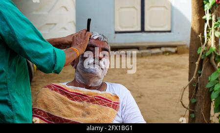 01 January 2021- Reengus, Sikar, India. Indian rural landscape, Local barber go to every day door to door to shave villagers. Stock Photo