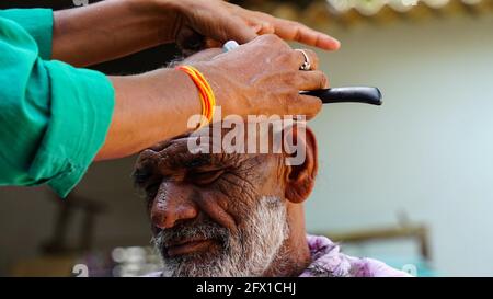 01 January 2021- Reengus, Sikar, India. A Traditional Barber Is Shaving A man In Village Of Sikar,India. Stock Photo