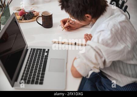 Pot maker preparing drawing of planned clay figure Stock Photo