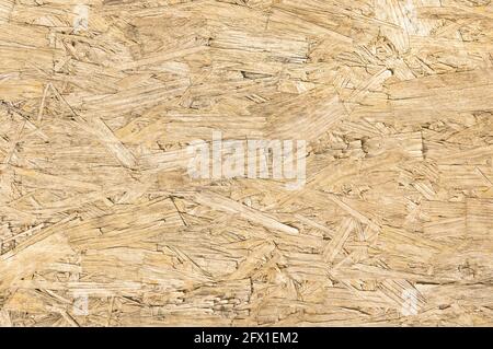 Chipboard wood background and alternative construction material - Texture on wooden panel in construction yard - Retro seamless backdrop pattern Stock Photo