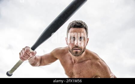 Violence and attack. Street fight. Attack and defence. Get ready attack. Man with baseball bat. Hooligan hits bat. Victory requires payment in advance Stock Photo