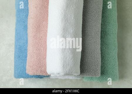 Clean rolled towels on textured background, top view Stock Photo