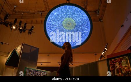 V&A, London UK. 25 May 2021. Epic Iran exhibition explores 5,000 years of art, design and culture through its journey into the 21st century. The exhibition runs from 29 May-12 September 2021. Image: Dome Projection of intricate tilework built up from sections (Luke Halls Studio, London) is positioned above the exhibition visitor. Credit: Malcolm Park/Alamy Live News. Stock Photo