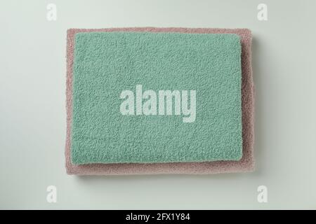 Clean folded towels on light gray background, top view Stock Photo