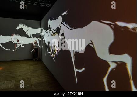 EMBARGOED till 00.01 25 May 2021 (ie available for print media tomorrow but not to be used online till then) - London, UK. 25 May 2021. Projections of Persian horses lead people to the exit - Epic Iran, a new exhibition at the V&A, opens as lockdown eases further. It explores 5,000 years of Iranian art, design and culture, bringing together over 300 objects from ancient, Islamic and contemporary Iran. It is the UK's first major exhibition in 90 years to present an overarching narrative of Iran from 3000 BC to the present day. Epic Iran is organised by the V&A with the Iran Heritage Foundation Stock Photo