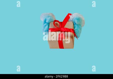 Christmas gift with red ribbon on blue background.  Copy space. Celebrating winter holidays, new year concept. Christmas banner layout, greeting card Stock Photo
