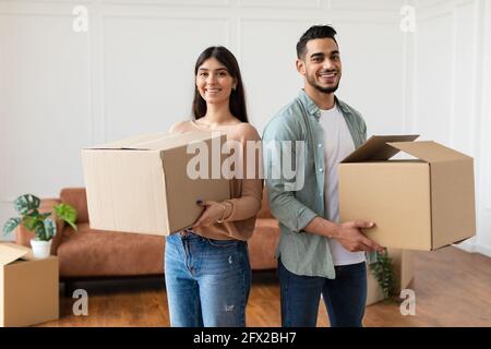 Happy man and woman holding cardboard boxes Stock Photo