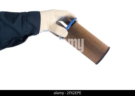 An auto mechanic holds an old dirty fuel filter in his hand. Fuel filter replacement concept, low-quality fuel, white background, isolate, equipment Stock Photo
