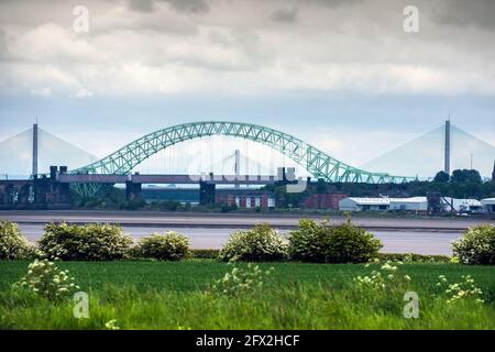 The Silver Jubilee Bridge crosses the River Mersey and the Manchester Ship Canalbetween Runcorn and Widnes, UK. Stock Photo