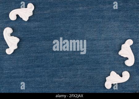 Beautiful decor of plaster stucco molding on denim. Top view. Copy space. Stock Photo