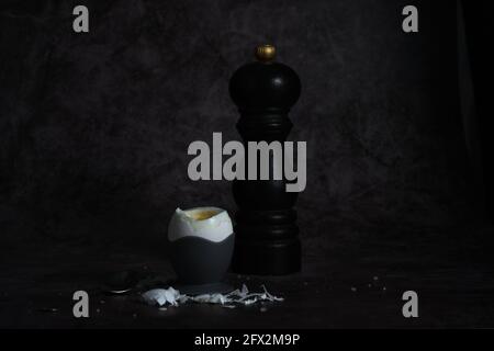 soft-boiled egg on a stand on a dark background Stock Photo