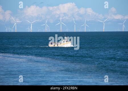 Sea Jay pleasure boat taking tourists on a pleasure cruise in Llandudno bay, North Wales with wind turbines in the background Stock Photo