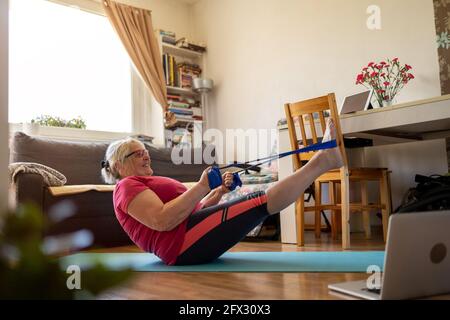 Senior woman exercising at home Stock Photo