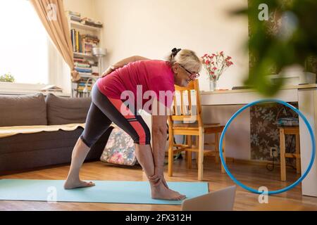 Senior woman exercising at home Stock Photo