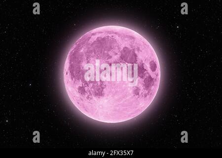 Full pink supermoon halo glowing surrounded by stars on black night sky background Stock Photo