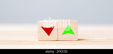 wood cube block with UP and Down arrow symbol icon on table. Interest rate, stocks, financial, ranking, mortgage rates and Cut loss concept