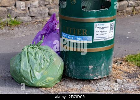 https://l450v.alamy.com/450v/2fx3dcr/a-bradford-council-litter-bin-with-full-rubbish-bags-tied-up-and-placed-next-to-it-ready-for-collection-2fx3dcr.jpg