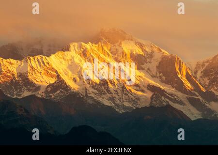 Sunset on Chaukhamba peaks, a mountain massif in the Gangotri Group of the Garhwal Himalaya. It lies at the head of the Gangotri Glacier at Uttarakhan Stock Photo